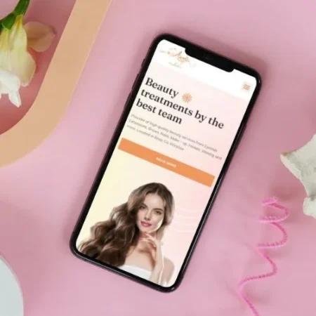 Modern business website displayed on a smartphone, showcasing mobile-friendly web design for beauty services.