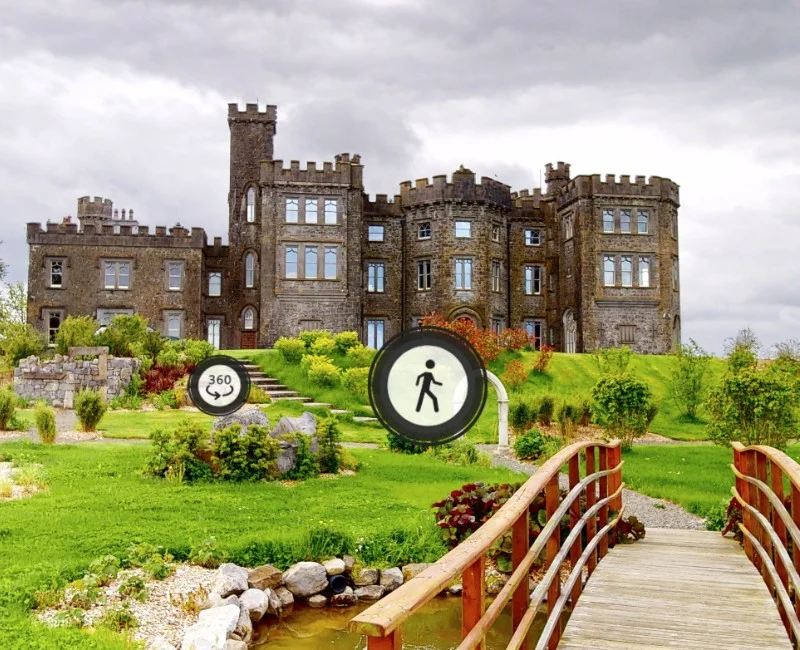 Interactive 3D virtual tour of a historic Irish castle with panoramic navigation icons over a landscaped garden