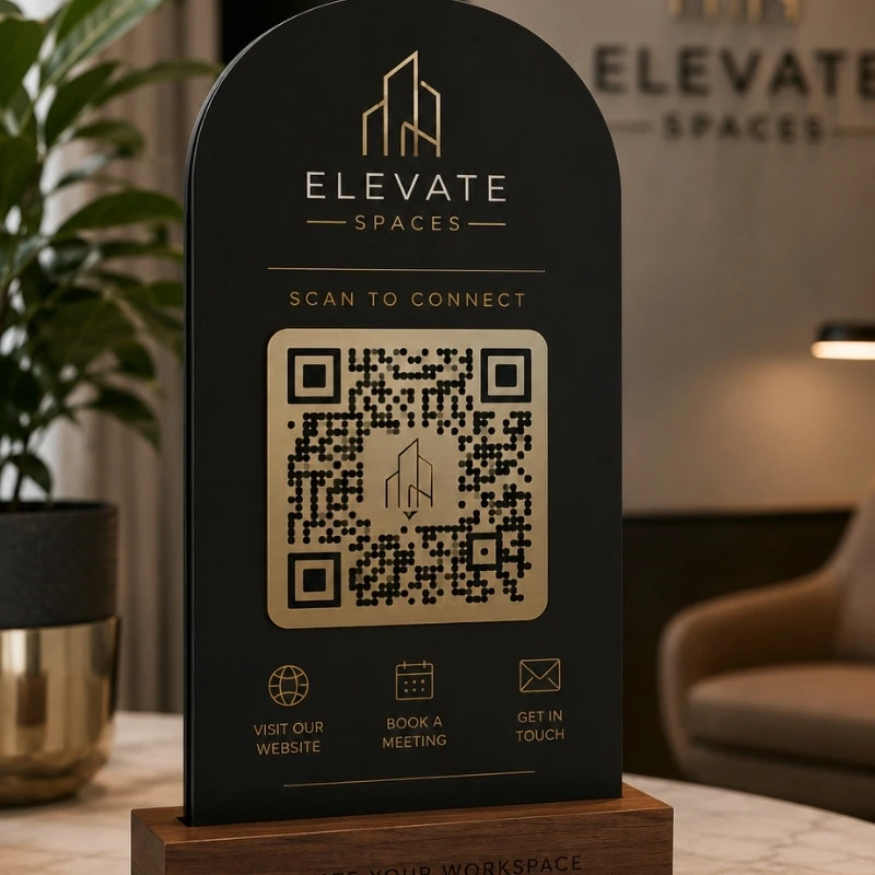 Premium black and gold QR code signage displayed in a luxury modern office reception for website access and client engagement